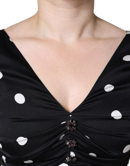 Dolce & Gabbana Schwarzes gepunktetes Midikleid aus Seide mit V-Ausschnitt und Quasten